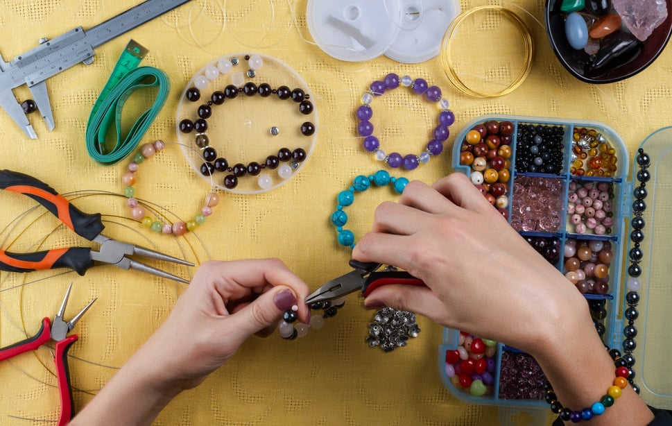 Jewelry making. Making a bracelet of colorful beads.